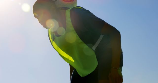 Silhouette of Construction Worker with Hi-Viz Vest Under Bright Sunlight - Download Free Stock Images Pikwizard.com