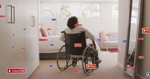 Senior Woman in Wheelchair Surrounded by Digital Icons at Home