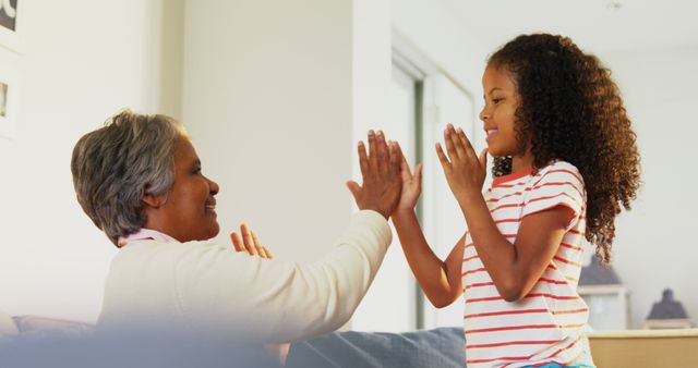 Grandmother and Granddaughter Playing Clapping Game Indoors - Download Free Stock Images Pikwizard.com