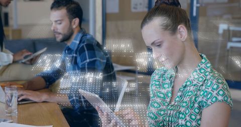 Binary Code Overlay on Business Professionals in Modern Office