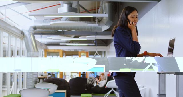 Businesswoman Standing at Desk on Phone in Open Office - Download Free Stock Images Pikwizard.com