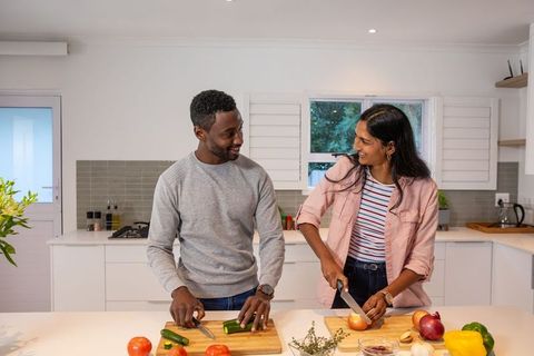 Smiling Couple Preparing Healthy Meal Together in Modern Kitchen