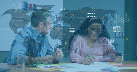 Creative professionals analyzing data with global map overlay