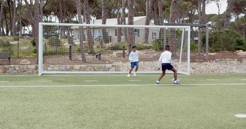 Diverse youth playing soccer on artificial turf