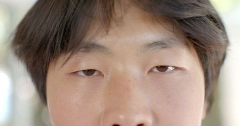 Close-up portrait of young asian student looking at camera