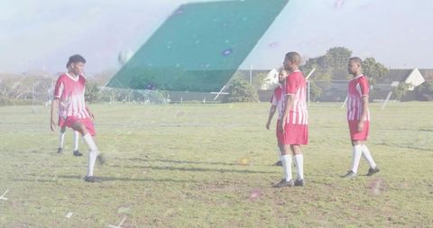Five male soccer players practicing passing and ball control on neighborhood grass field