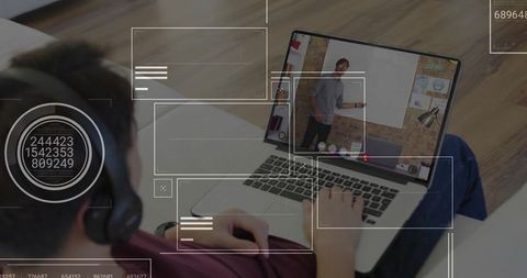 Teenage boy engaged in online learning at home on laptop