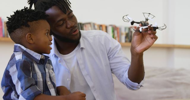 Father and Son Exploring Drone Technology Indoors - Download Free Stock Images Pikwizard.com