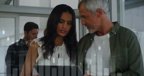 Analysts Collaborating with Financial Data on Tablet