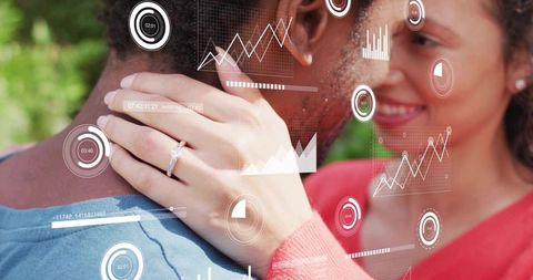 Couple embracing showing engagement ring with futuristic hud overlay in park