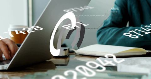 Business analysts collaborating with data overlays on laptop and notebook for visualization