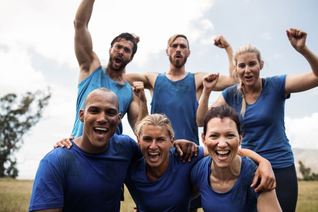 Fit people cheering together in boot camp