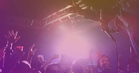 Energetic Singer Performing on Stage at a Packed Club Night