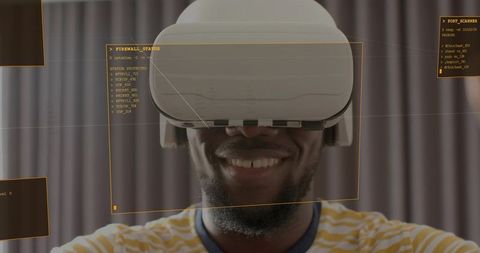 Smiling man wearing vr headset interacting with futuristic orange hud and terminal overlay