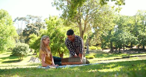 Young Couple Enjoying Serene Park Picnic Outdoors