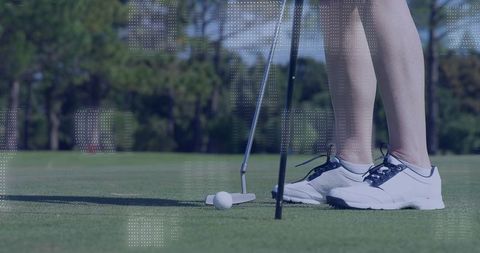 Close-Up of Golfer Aligning Putt on Green in Sporting Gear
