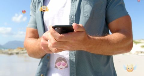 Young Man Messaging with Emoticons Over Smartphone Outdoors - Download Free Stock Images Pikwizard.com