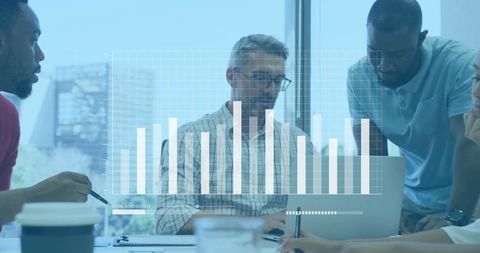 Team Analyzing Business Data on Laptop with Graph Overlay