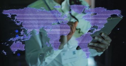 Technologist interacting with digital world map in data center