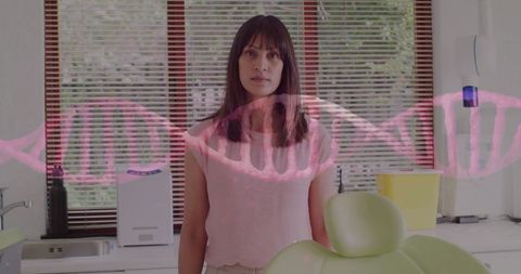 Woman standing in dental office with dna helix overlaying