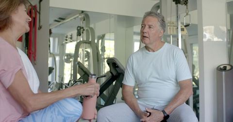 Active Senior Couple Relaxing in Fitness Gym Environment