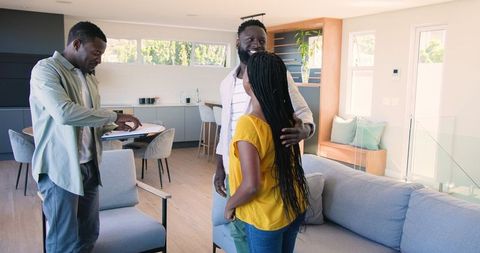 Family welcoming guest in contemporary living space