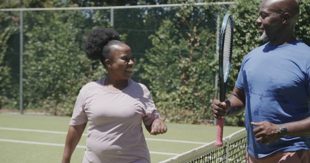 Senior African American Couple Playing Tennis on Tennis Court - Download Free Stock Images Pikwizard.com