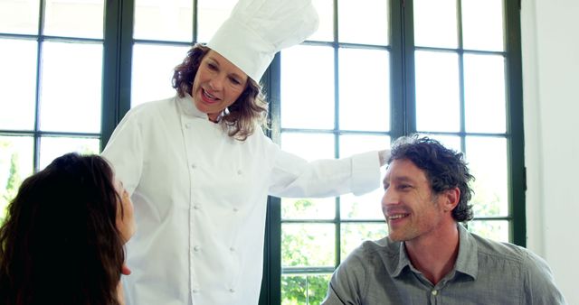 Smiling Chef Interacting with Restaurant Patrons By Window - Download Free Stock Images Pikwizard.com