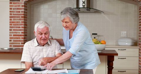 Senior couple managing finances at home
