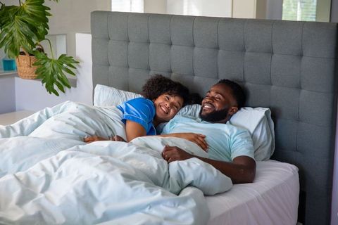 Happy couple relaxing in comfortable bedroom setting