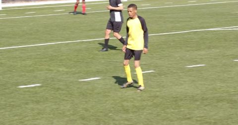 Youth Soccer Player on Field Ready for Action