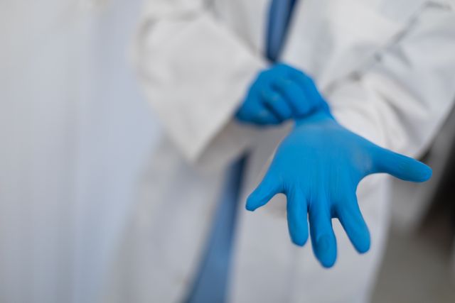 Doctor Putting on Blue Surgical Gloves - Download Free Stock Photos Pikwizard.com