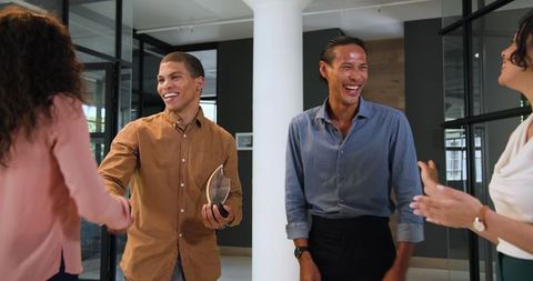 Diverse Team Celebrating Award Ceremony in Office