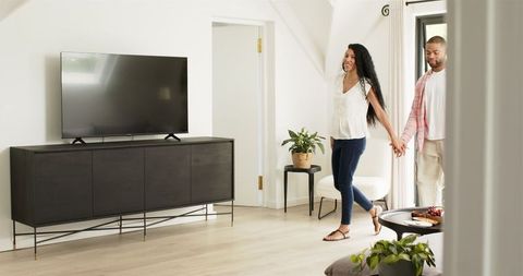 Man Proposes to Woman with Ring in Bright Living Room