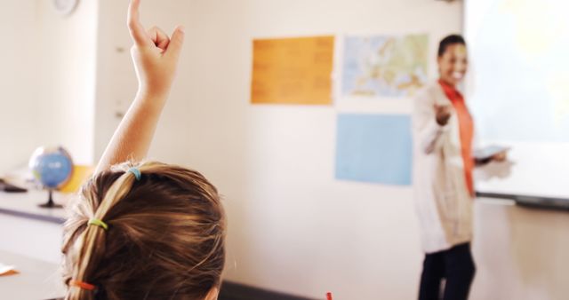 Student with Raised Hand Participating in Classroom Discussion - Download Free Stock Images Pikwizard.com