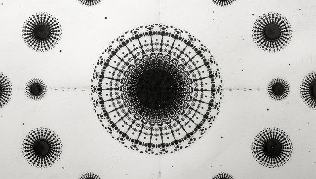 High-contrast Monochrome Radial Ink Mandala on White Panel with Central Geometric Burst