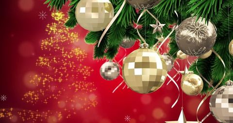 Festive Christmas Baubles Hanging on Tree with Snowfall