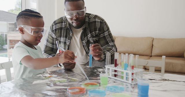 Father engaging daughter in hands-on science experiments at home. Great for educational content, promoting STEM activities for kids, family bonding, home schooling, and science campaigns.