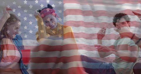 Friends relaxing on beach holding red cup with american flag overlay
