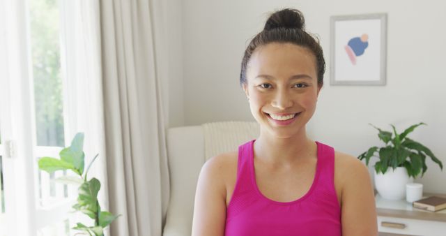 Smiling Woman in Pink Tank Top at Home Bright Living Space - Download Free Stock Images Pikwizard.com