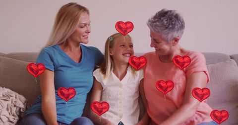 Happy family sitting together with floating heart balloons