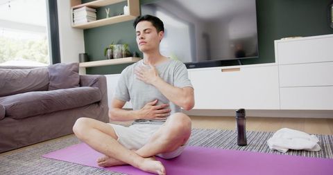 Man Practicing Mindful Yoga and Meditation at Home