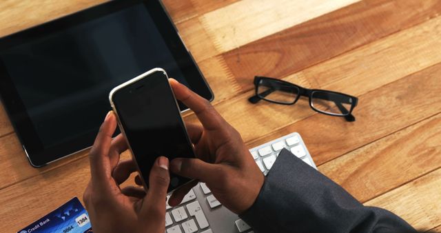 Businessperson Using Smartphone and Tablet at Work Desk - Download Free Stock Images Pikwizard.com