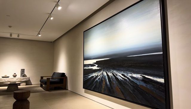 Oversized abstract coastal landscape painting dominating minimalist gallery interior