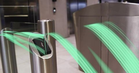 Steel Turnstile Scanning Smartphone with Green Light Trails in Office Entrance