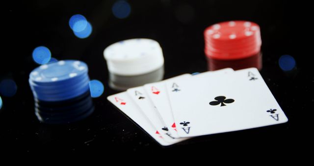 Close-up of four aces laid out with stacked poker chips. Ideal for articles about poker strategies, casino marketing materials, or gambling-themed graphics.