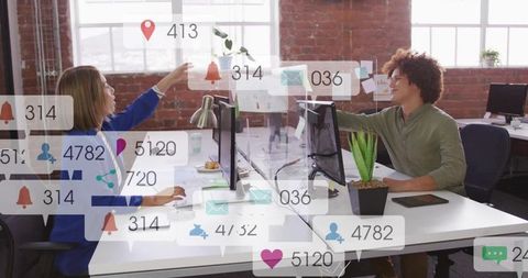 Reaching coworker exchanging file in modern open-plan office with notification overlays