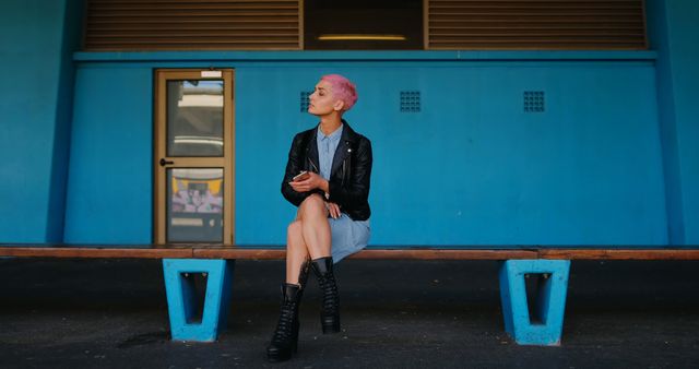 Stylish Woman with Pink Hair Sitting on Bench with Smartphone - Download Free Stock Images Pikwizard.com