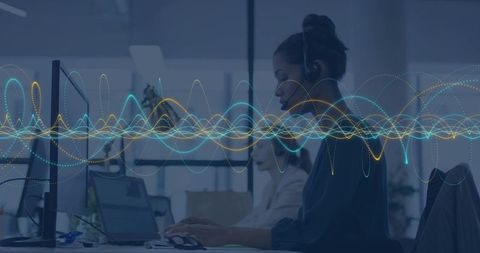 Customer Service Agent Typing with Headset in Modern Open Office with Data Waveform Overlay