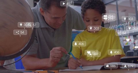 Adult mentor guiding boy writing in classroom with globe and social media engagement icons